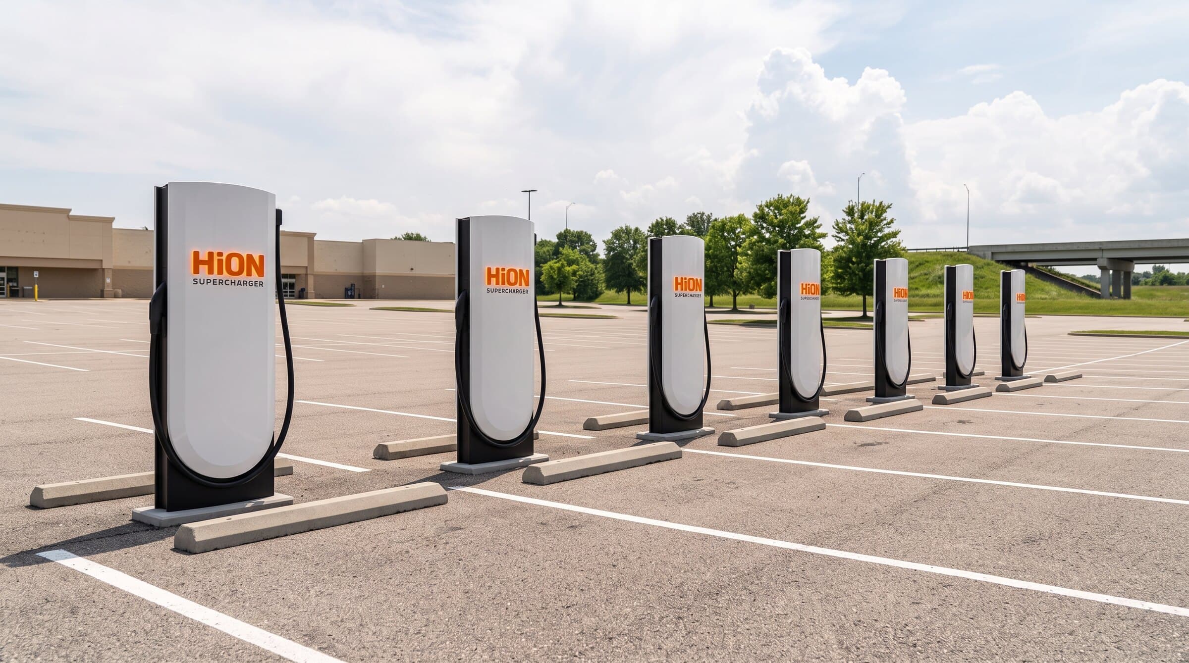 Rendering of HiON Supercharger pillars in a wide Illinois retail lot beside the interstate — matte-white, each with the glowing orange HiON wordmark, bays empty and no vehicles present. Brand imagery, not a photograph of this station.